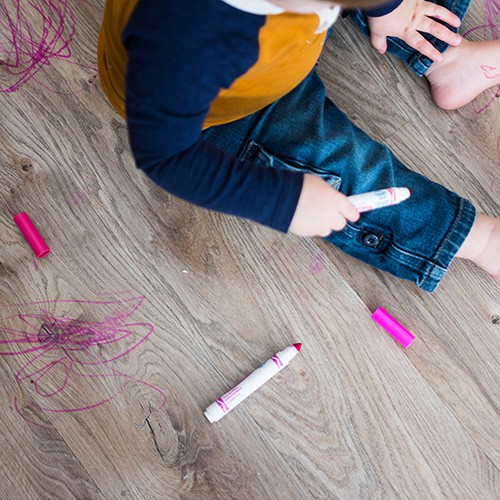 Little boy draws with marker on floor Little boy draws with marker on floor | The Design House