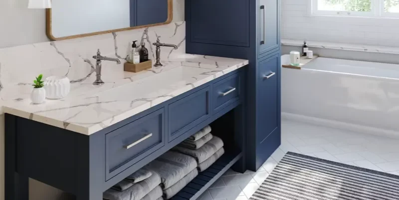 Modern bathroom with blue cabinets and marble countertops