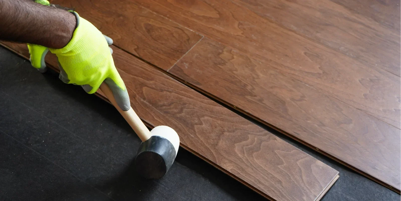 Flooring professional installing hardwood flooring