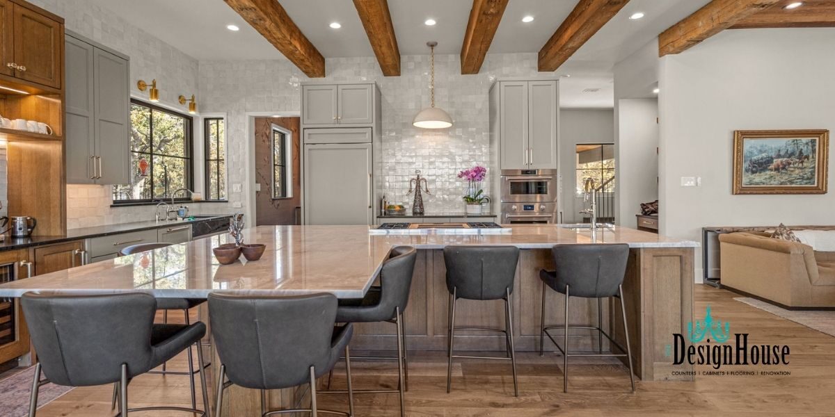 farmhouse style kitchen with wooden beams and large natural stone island