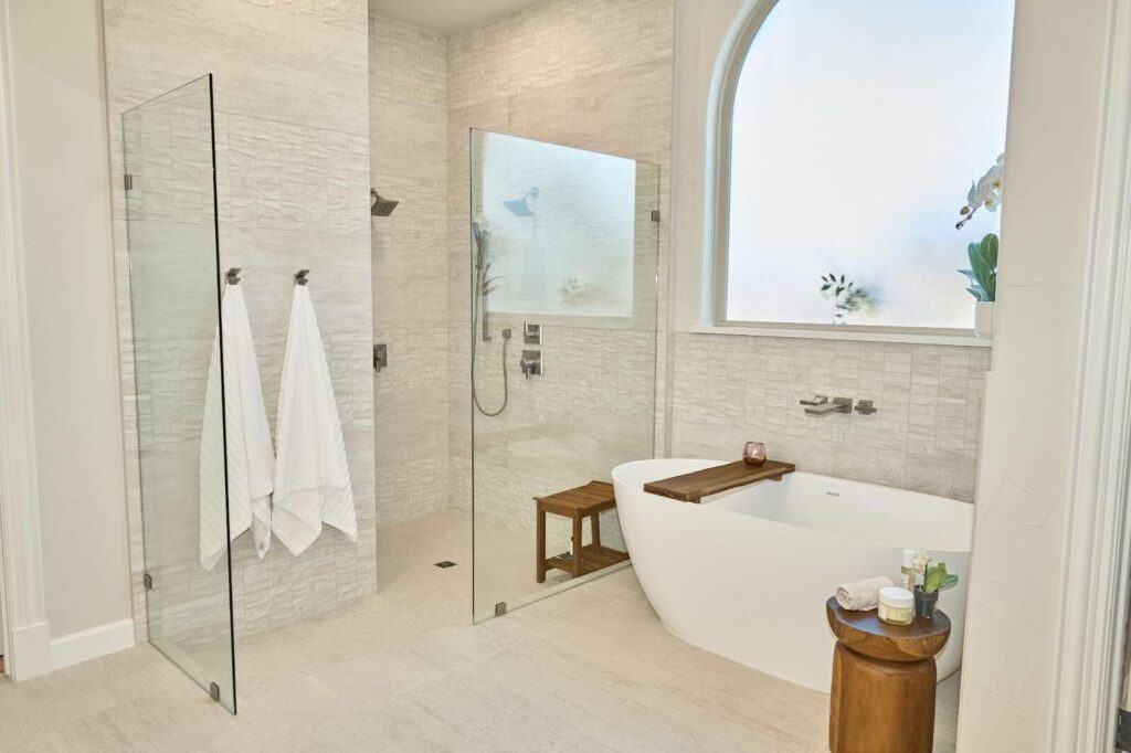 Spa master bath with white natural stone tile and soaker tub