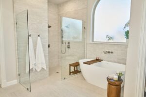 Spa master bath with white natural stone tile and soaker tub