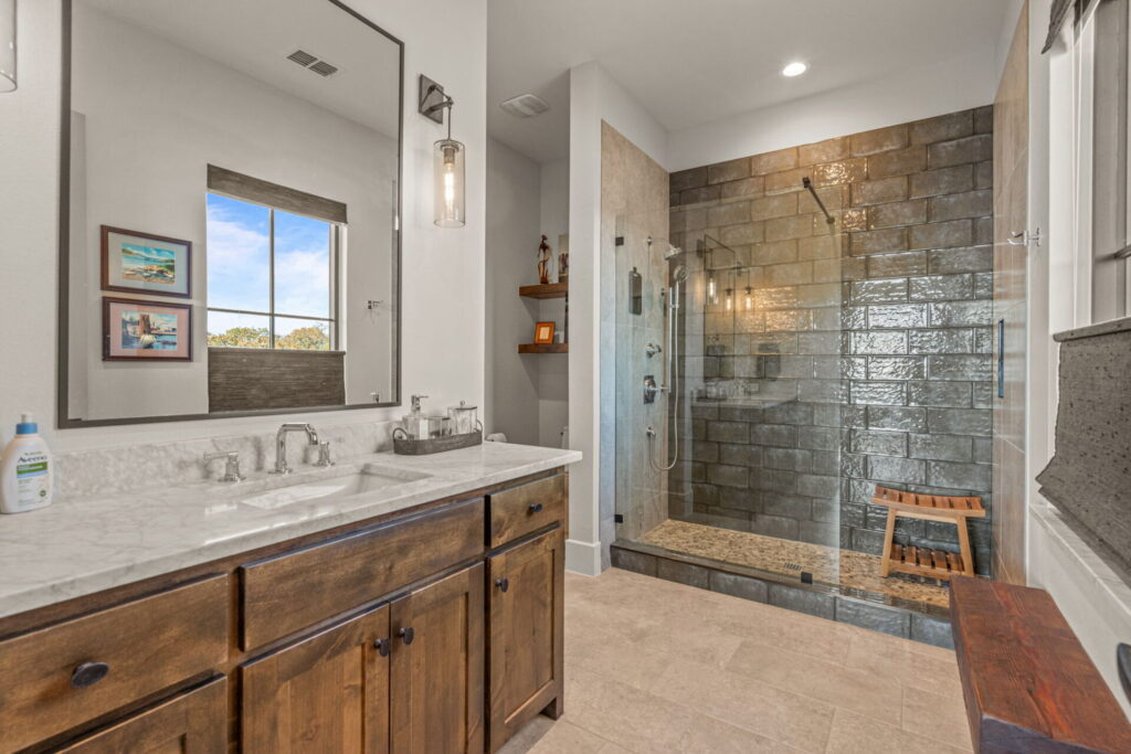 dark tile shower glass enclosure marble counter guest bath | The Design House